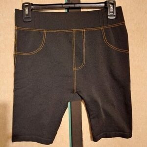 Black stretchy legging shorts with stitch details.